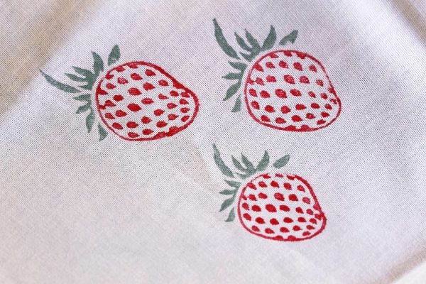 Block printed strawberry tea towel close up